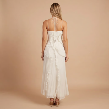 Back view of cream pleated midi dress with tie-back halter closure