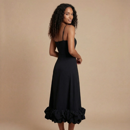 Back view of black ruffle midi dress with gathered hem detail