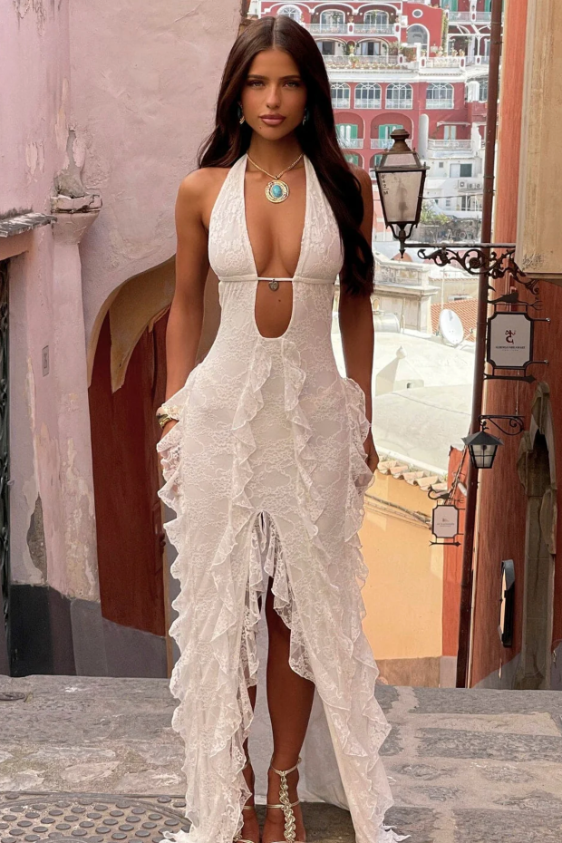 White lace maxi dress with plunging halter neckline and dramatic ruffled hem detail