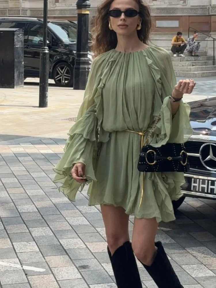 Sage green ruffle mini dress with flutter sleeves and waist detail, side view