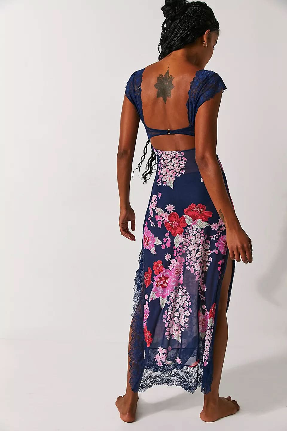 Back view of navy floral midi dress with lace cutout detail and side slit