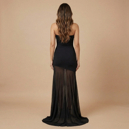 Back view of black strapless maxi dress with sheer mesh skirt