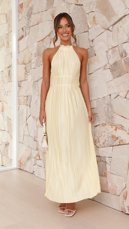 Front view cream pleated maxi dress with halter neckline and waist detail