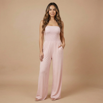 Pale pink strapless smocked jumpsuit with functional pockets and relaxed fit