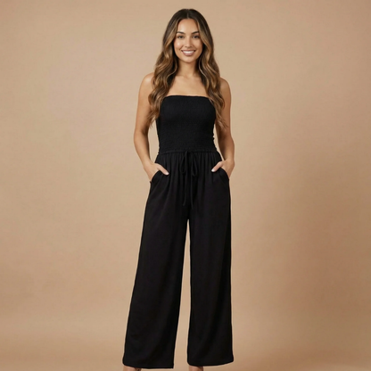 Black strapless smocked maxi jumpsuit with wide-leg pants and front pockets