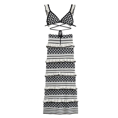 Flat lay of black and white geometric knit bikini top and tiered midi skirt with diamond patterns