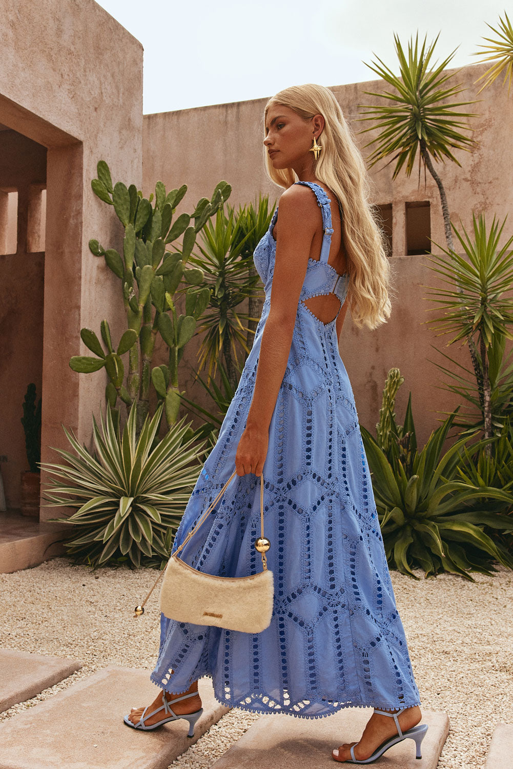 Side profile of periwinkle maxi dress showing back cutout and lace detailing