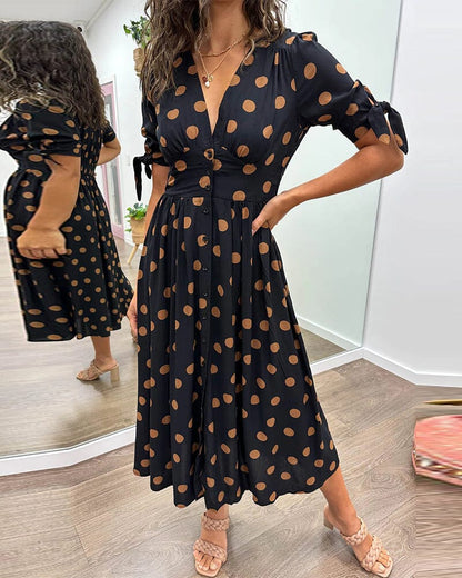 Black wrap midi dress with caramel polka dots, puffed sleeves front view