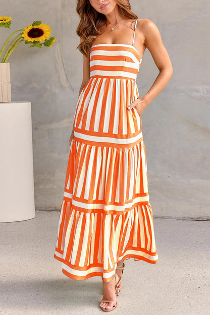 Orange and white striped women's maxi dress with fitted bodice and flowy pleated skirt