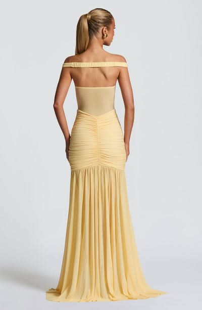 Back view of pale yellow maxi dress with ruched waist and pleated skirt