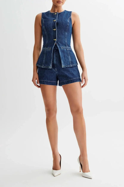 Front view of blue denim shorts set with peplum vest detail