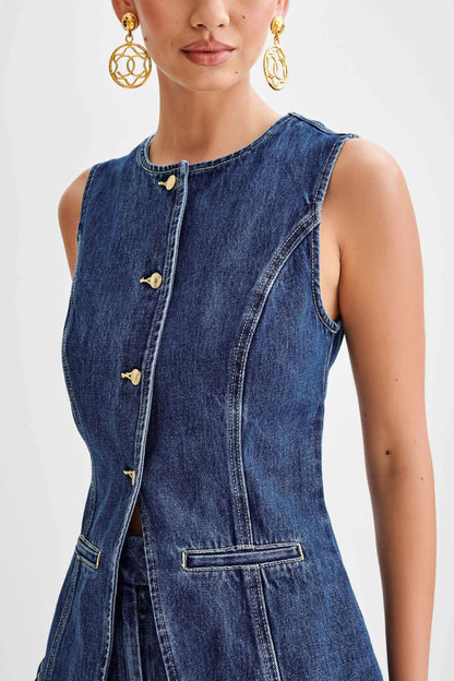 Close-up of blue denim vest front with gold button closures