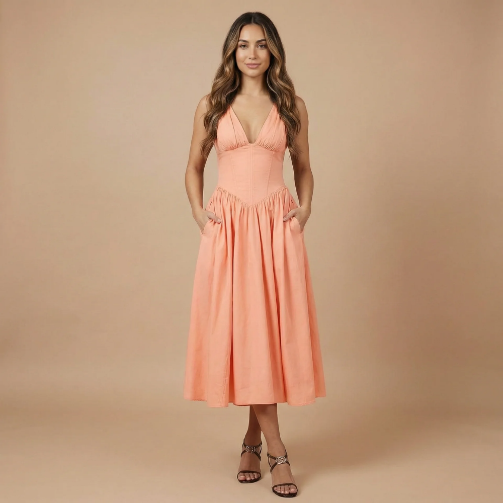 Coral sleeveless corset midi dress with fitted bodice and full skirt