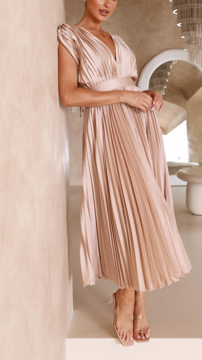 Blush pink pleated midi dress side view with flowing pleated skirt