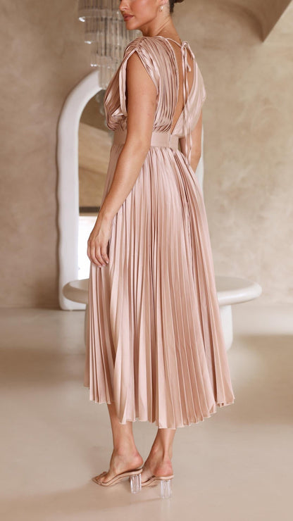 Back view of blush pleated midi dress with open back detail