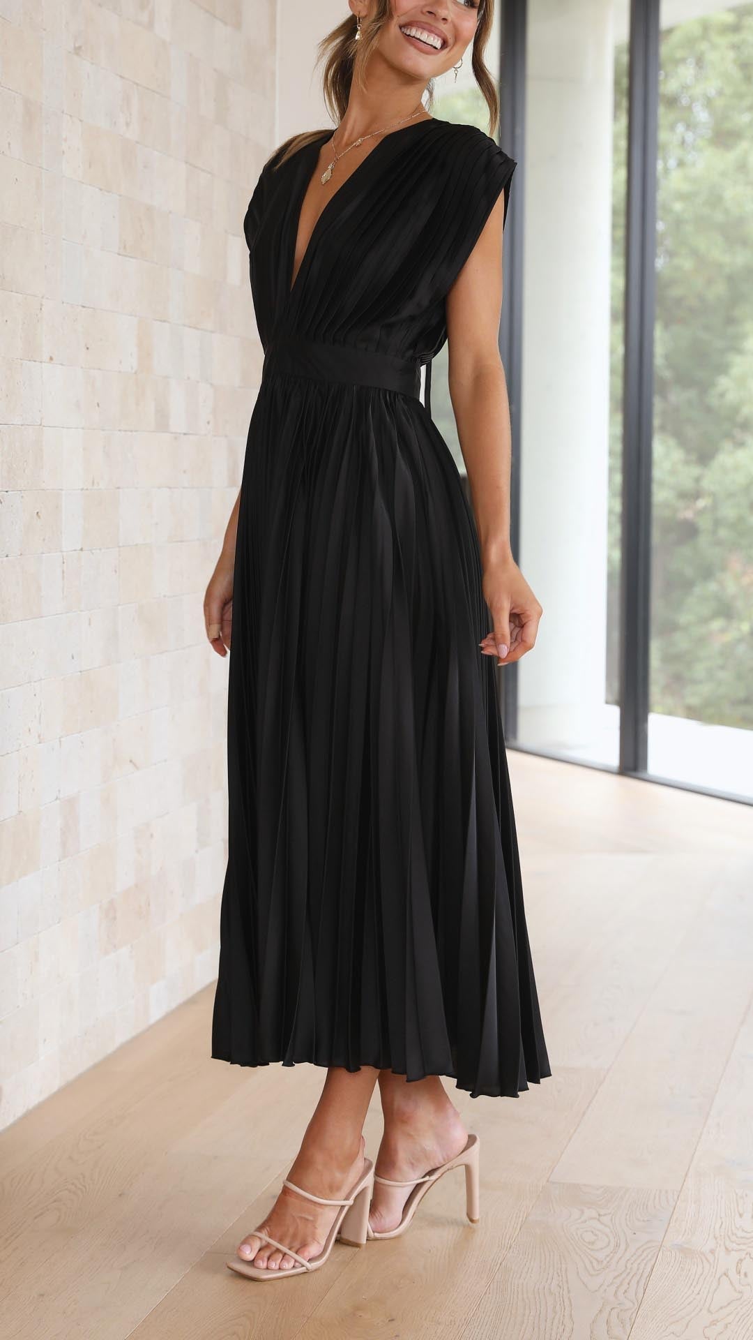 Black pleated midi dress with cap sleeves and flowing skirt
