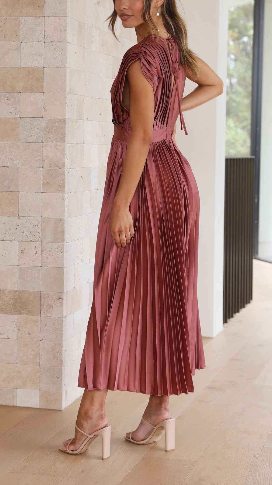 Side view of mauve pleated midi dress showing open back detail