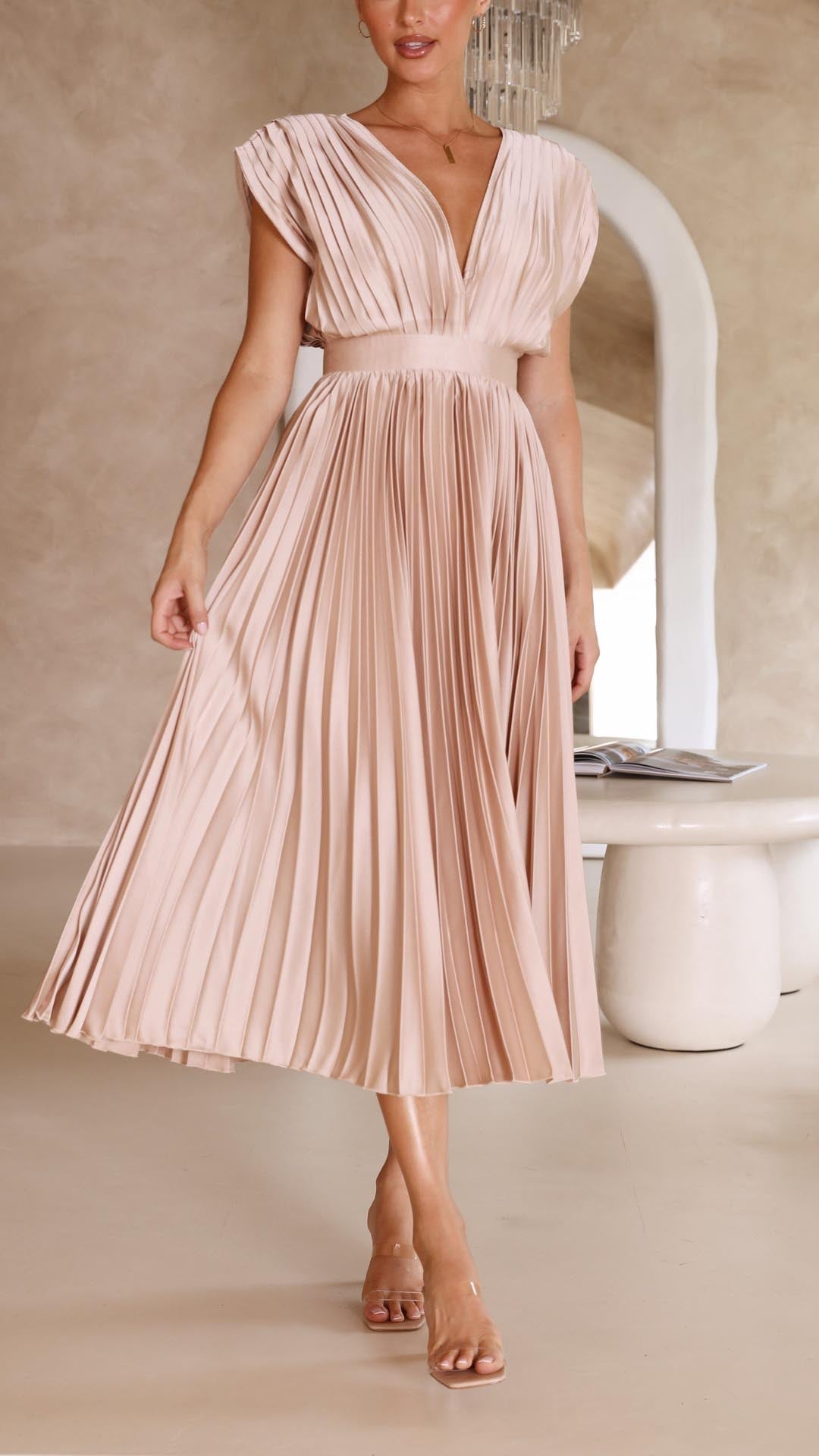 Blush pink pleated midi dress side profile showing draped skirt