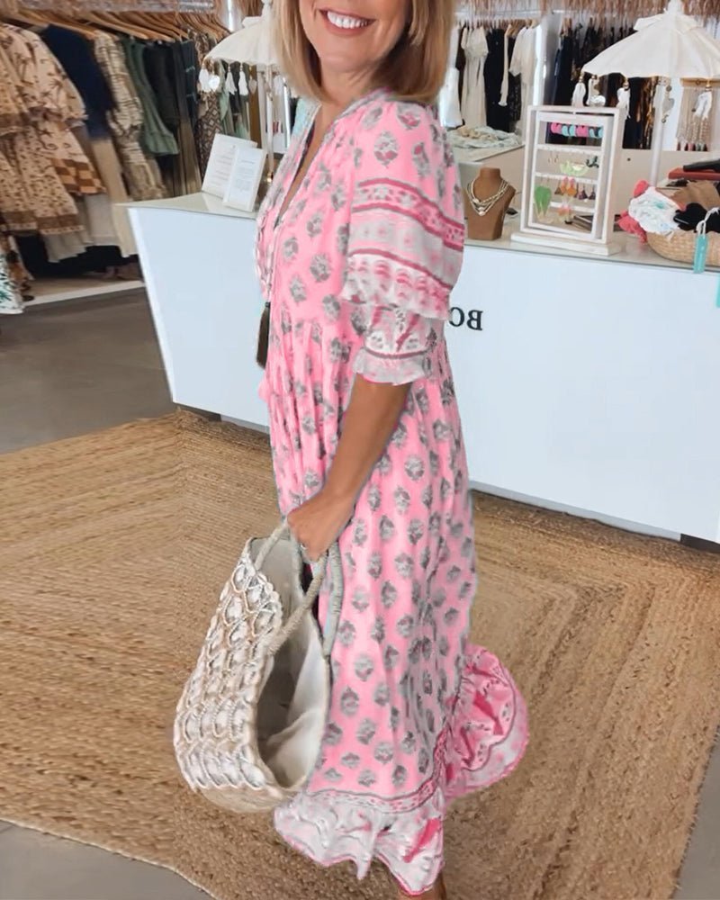 Pink floral tiered maxi dress with lace trim and decorative waistband detail