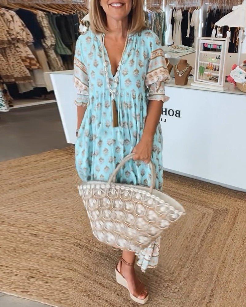Light blue floral tiered maxi dress with three-quarter sleeves and lace cuffs