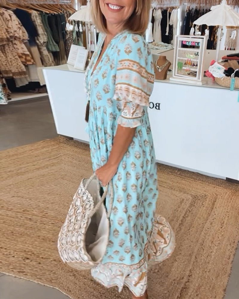 Light blue floral maxi dress side view showing tiered layers and flowing silhouette