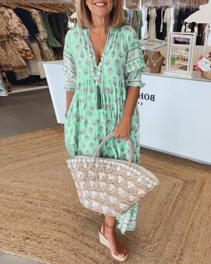 Back view of mint green floral maxi dress with decorative pattern bands