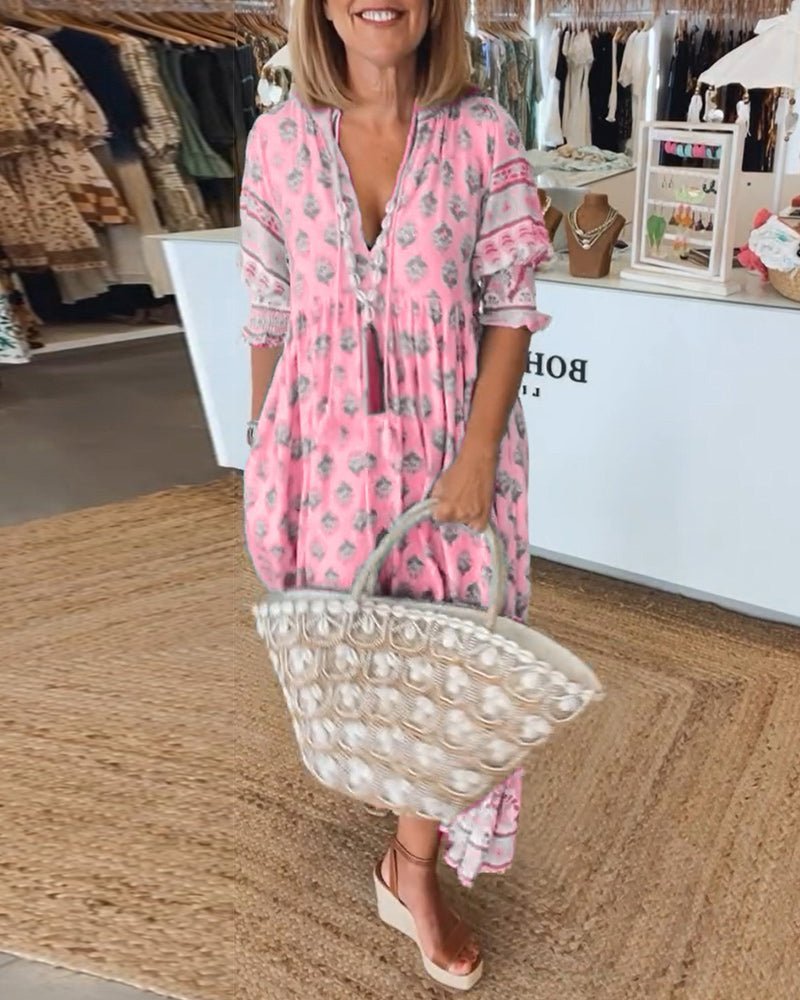 Pink floral maxi dress with layered tiers and decorative sleeve cuffs
