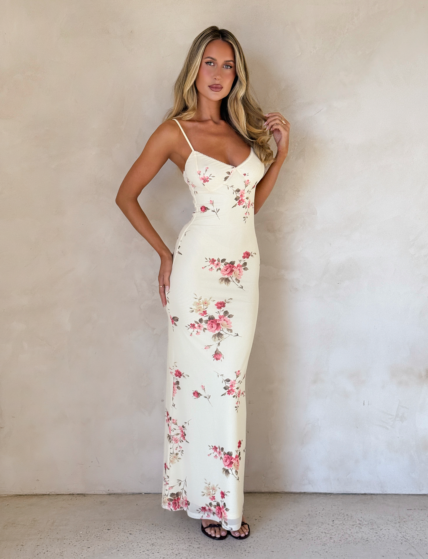 Front full-length view of cream floral maxi dress with rose pattern