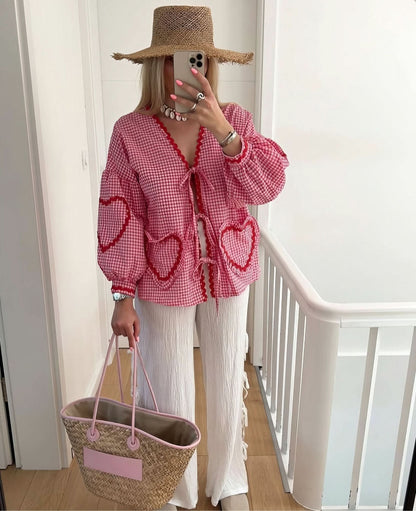 pink checkered top with ruffle heart pockets and tie-front closure detail