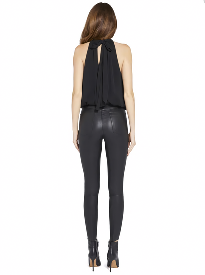 Back view of black pleated halter mini dress with tie closure