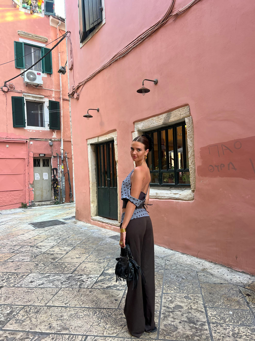 Black tailored pants with sage polka dot waistband, back view full length