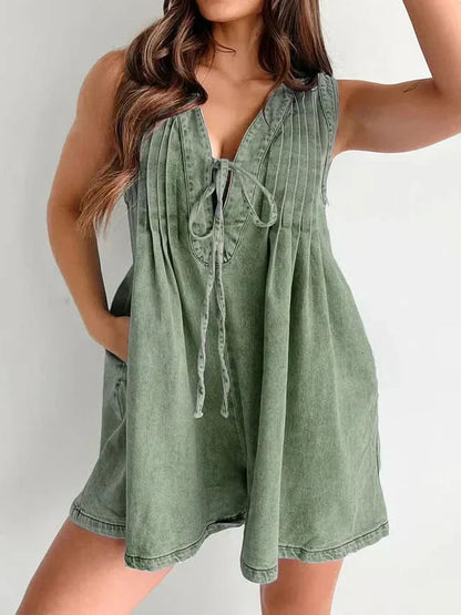 Sage green lace-up mini romper with pleated front and V-neckline
