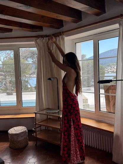 Back view of red floral maxi dress with open back and flowing train