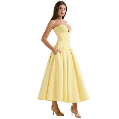 Pale yellow strapless corset midi dress with structured bodice and pleated skirt