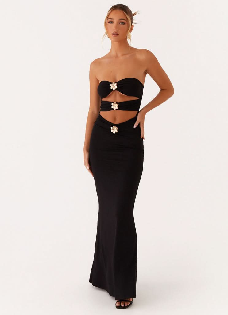 Black strapless cutout maxi dress with gold embellished straps and waist details