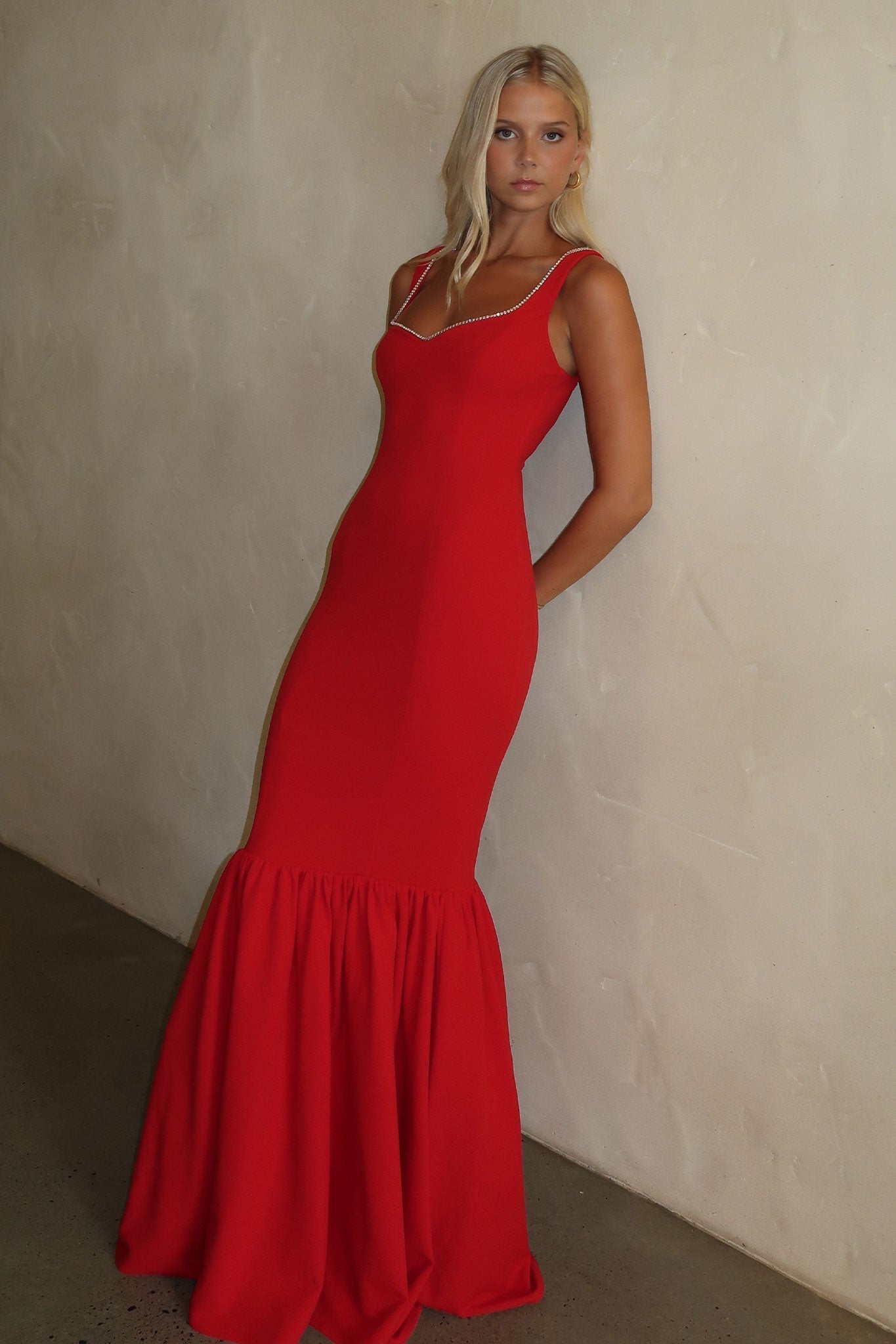 Red formal maxi dress with fitted bodice and flared hem detail for women
