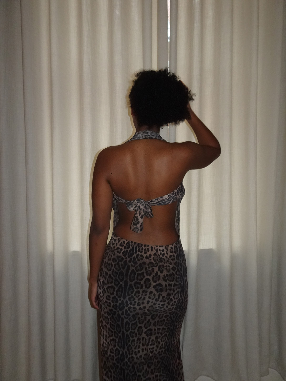 Leopard maxi dress with halter tie back and floor-length silhouette