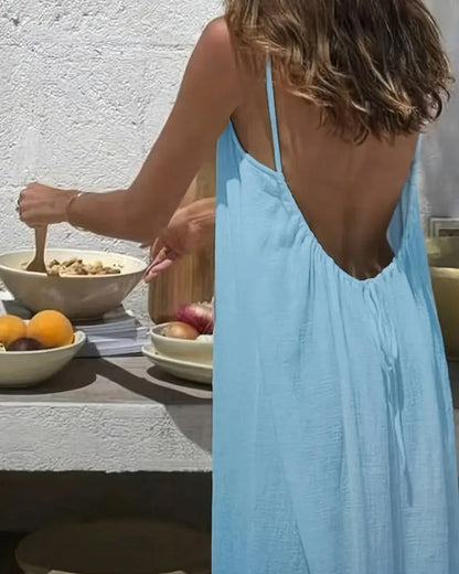 Back view of light blue backless maxi dress showing open back design and draped fabric