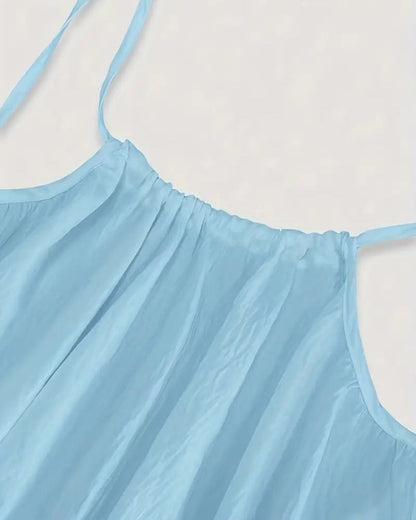 Close-up of light blue maxi dress neckline and pleated fabric texture detail