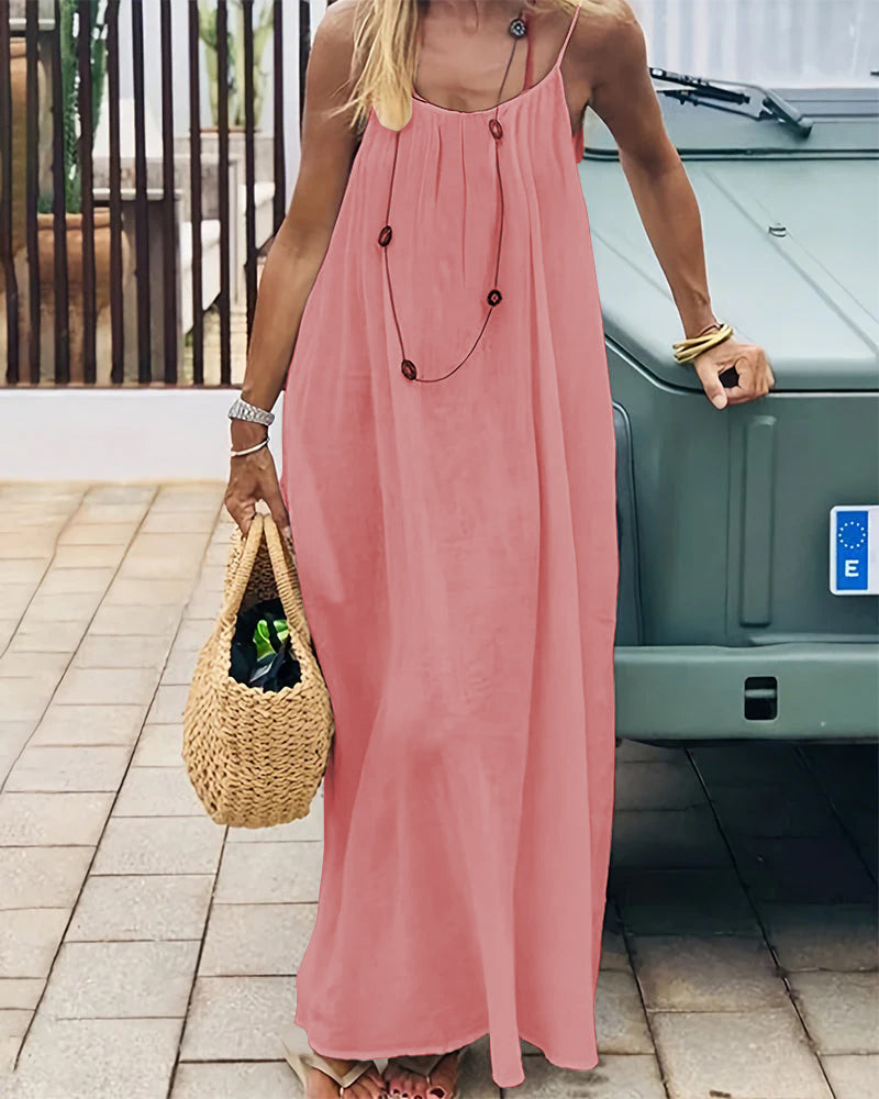 Coral pink sleeveless maxi dress with gathered bodice and floor-length hem