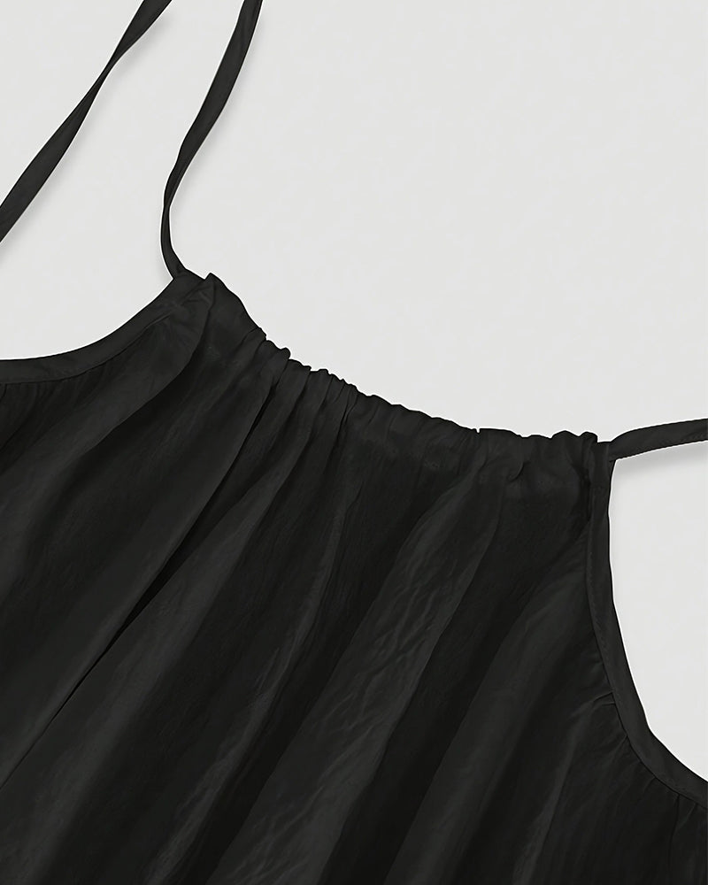 Close-up of black maxi dress neckline with pleated bodice detail