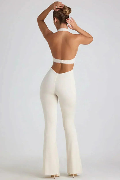 Rear view of cream backless jumpsuit with low-cut back and flared pants