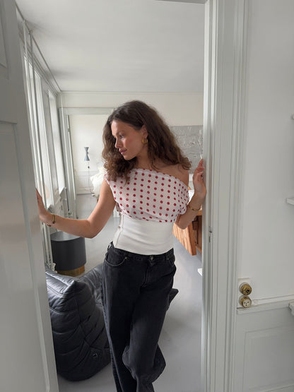 Polka dot draped crop top styled with black denim, back view