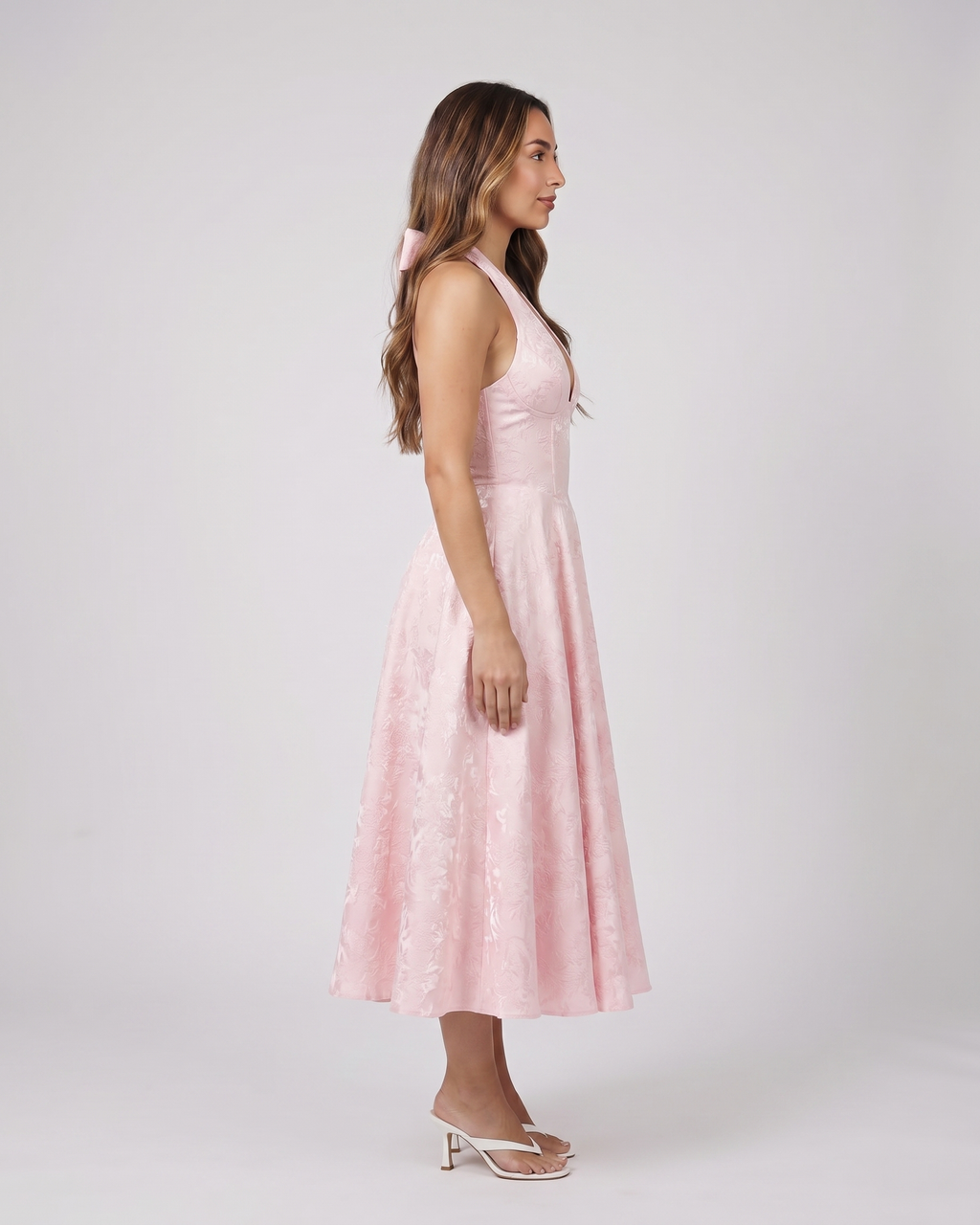 Side view of pink floral jacquard halter midi dress