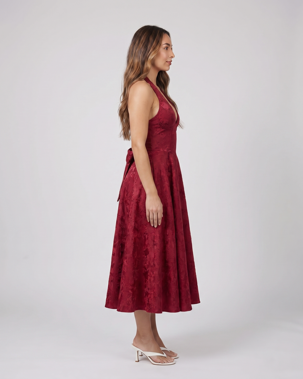 Side view of red floral jacquard halter midi dress