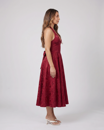 Side view of red floral jacquard halter midi dress