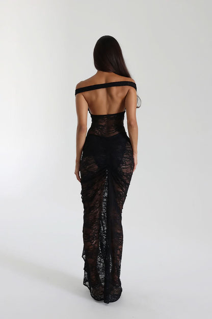 Back view of black lace maxi dress with open back and ruched side detail