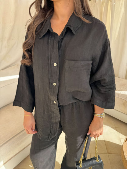 Black linen button-up shirt close-up with pocket detail