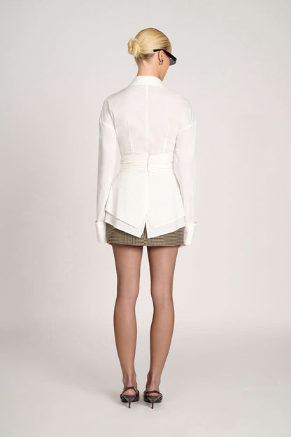 Back view of white ruched collared top with gathered waist detail
