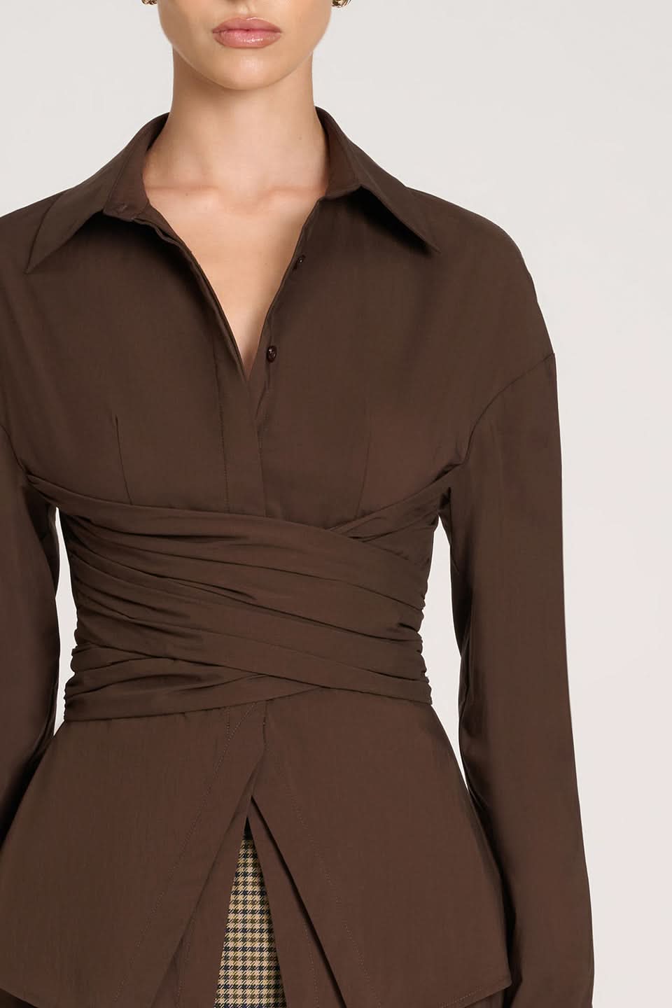 Close-up of brown collared top showing ruched bodice and button front